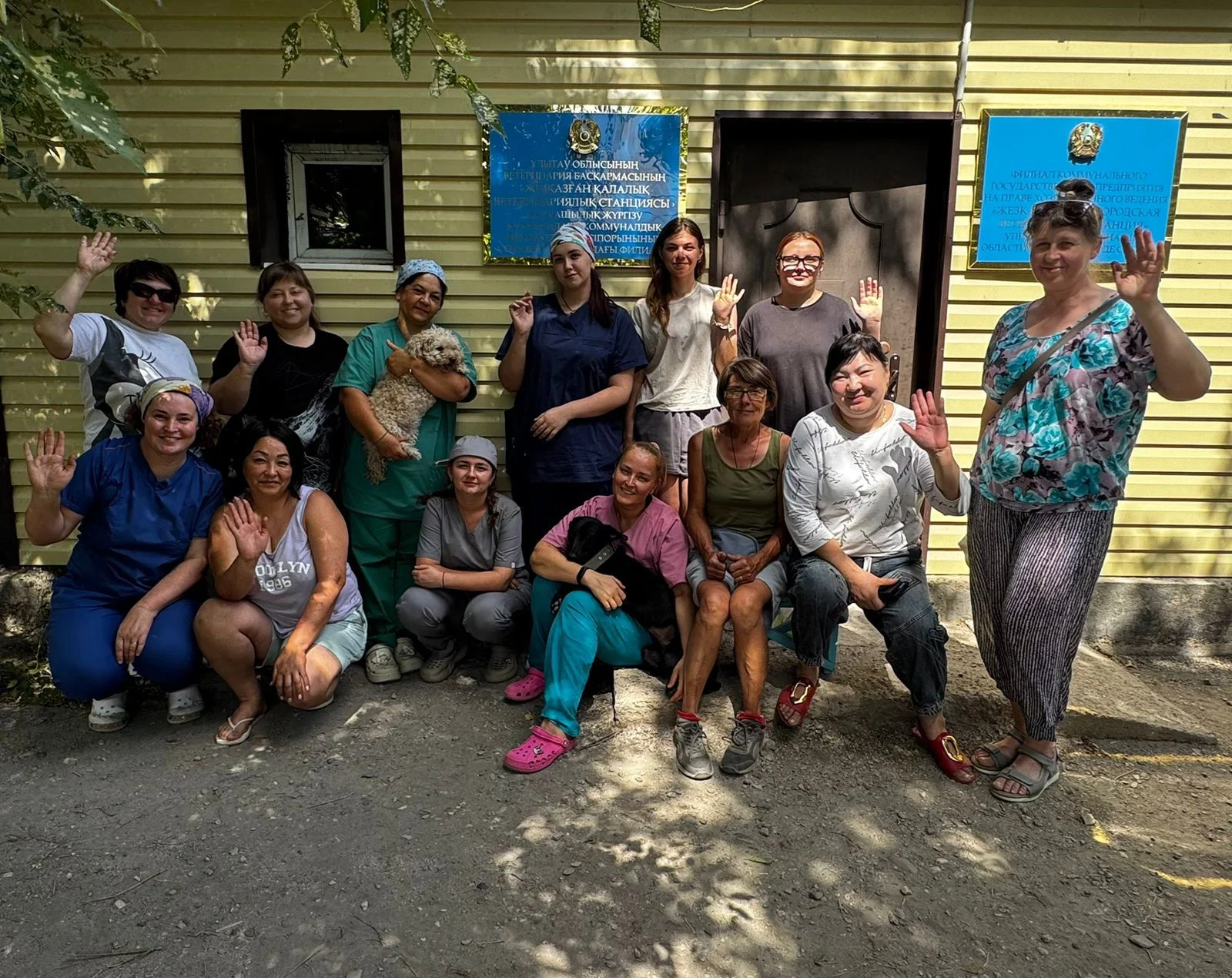 Vets and volunteers standing outside a campaign building