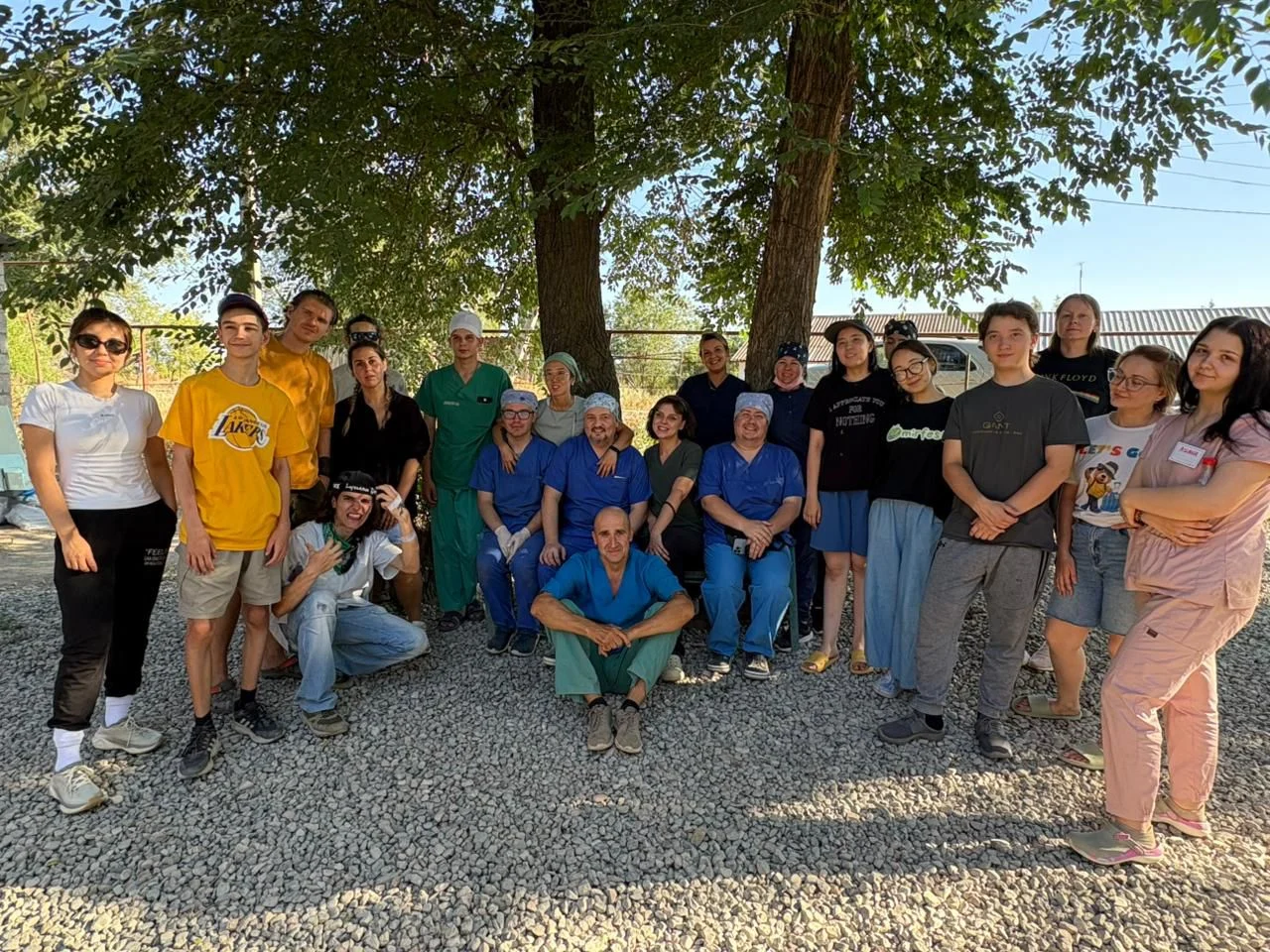 A large group of vets and volunteers standing outdoors